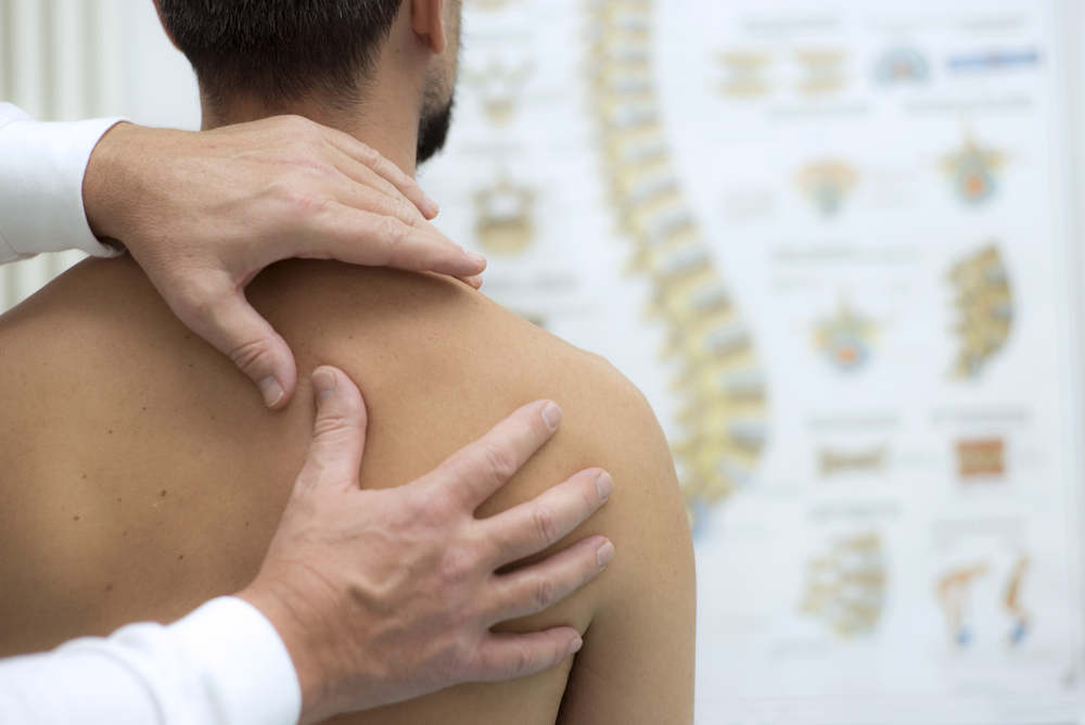 Chiropractor examining patients posture