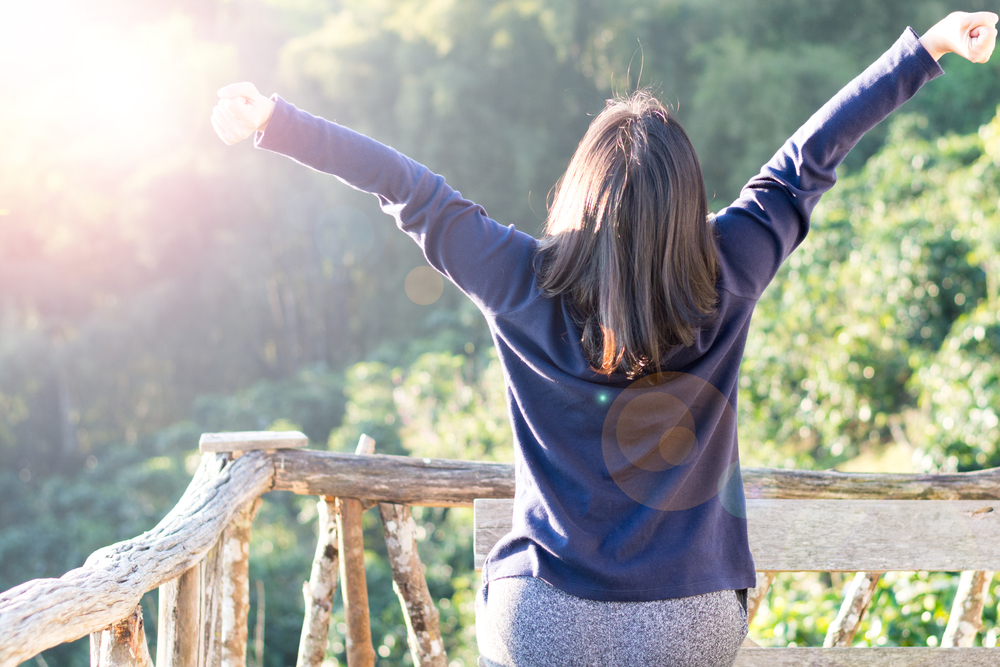 Woman naturally feeling good with arms outstretched