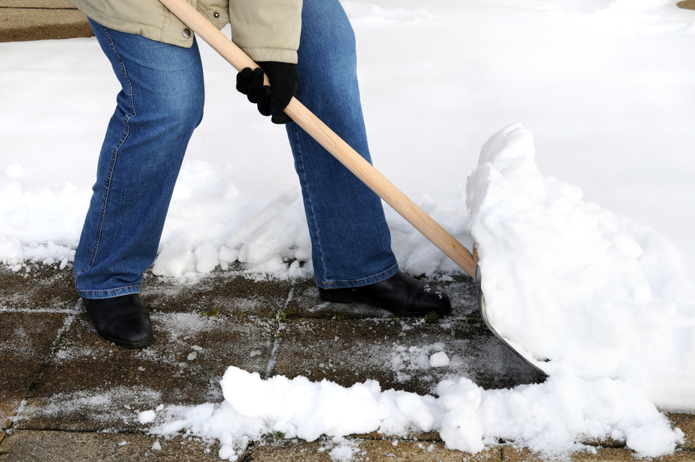 Woman shoveling snow