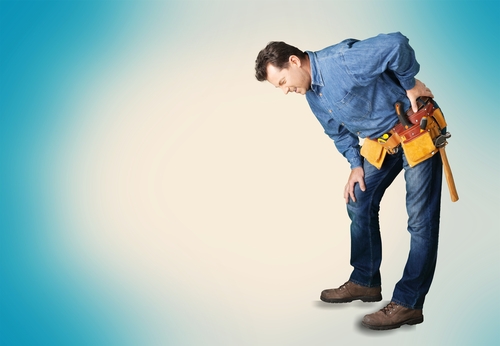 carpenter wearing tool belt with back pain