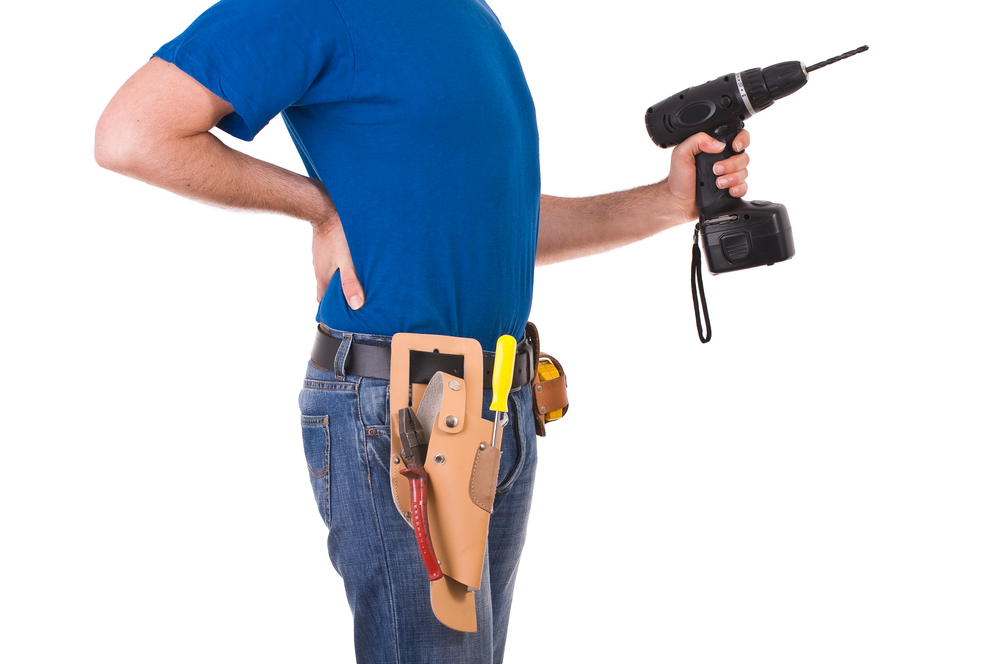 carpenter back pain holding a power drill