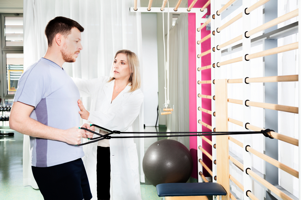 man exercising with a chiropractor correcting their posture