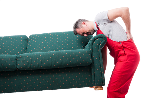 man in back pain after lifting couch